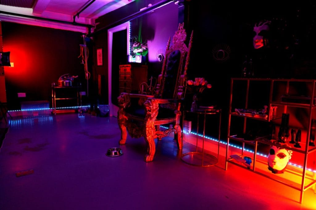 Throne corner of the play room under purple and red lighting